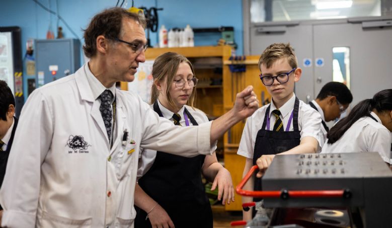 Image of teacher and students using vacuum former
