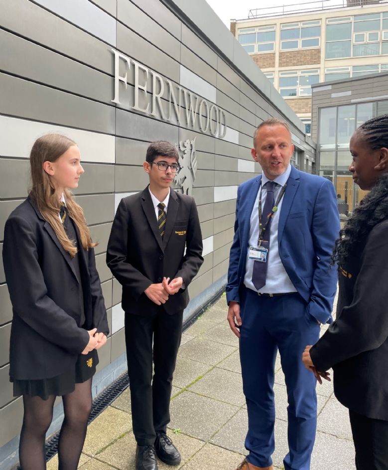 Image of Head Teacher talking to some Fernwood students